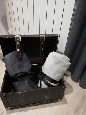a black suitcase with a pillow and a towel at Piso Ourense Centro in Ourense