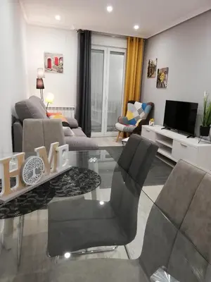 a living room with a couch and a table at Piso Ourense Centro in Ourense