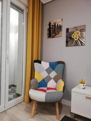 a chair with a quilt on it in a room at Piso Ourense Centro in Ourense