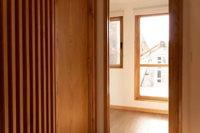 an open door to a room with a window at Ferreiros - Wood Design apartments in Puentedeume
