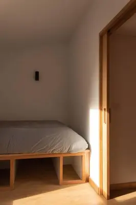 a bedroom with a bed and an open door at Ferreiros - Wood Design apartments in Puentedeume