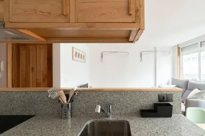 a kitchen with a sink and a counter top at Ferreiros - Wood Design apartments in Puentedeume