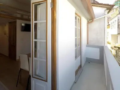 an empty room with a door and a window at Ferreiros - Wood Design apartments in Puentedeume