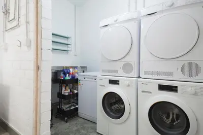 a laundry room with two washer and dryer at Apartamentos Turísticos As Burgas 6 by Bossh! Hotels in Ourense