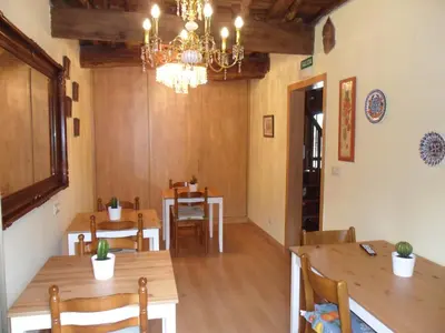 a dining room with wooden tables and a chandelier at Casa Da Vieira in Ourense