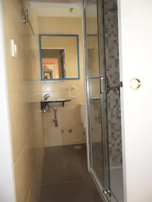a bathroom with a shower with a sink and a mirror at Casa Da Vieira in Ourense