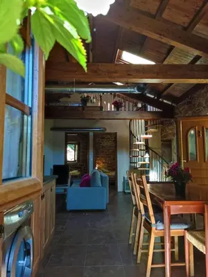 a kitchen and living room with a table and chairs at Casa do Castiro in Palas de Rei