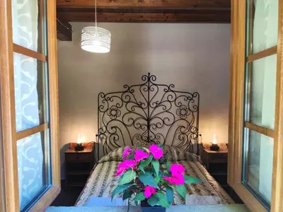 a bedroom with a bed with pink flowers on it at Casa do Castiro in Palas de Rei