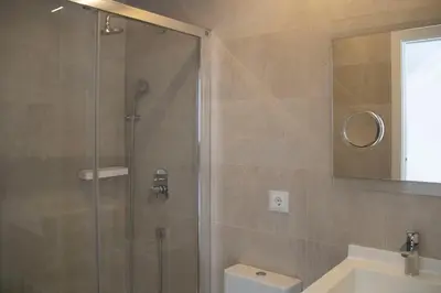 a bathroom with a shower and a toilet and a sink at Hotel Alda San Bieito in Santiago de Compostela