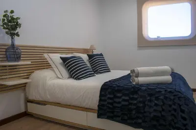 a bedroom with a bed with pillows and a window at Ciudad Coruña Estación Manzaneda in Prada