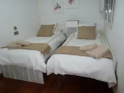 two beds sitting next to each other in a room at Las Palmeras in Caldas de Reis