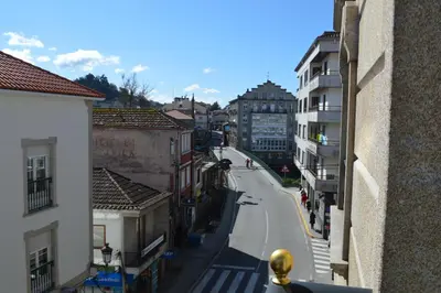 a view of a street in a city with buildings at Las Palmeras in Caldas de Reis