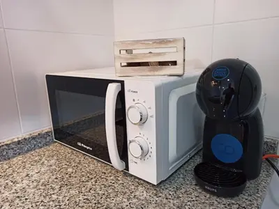 a microwave sitting on a counter next to a blender at Casa do Xuli in Viveiro