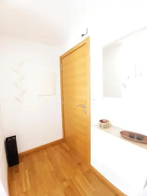 a room with a wooden door and a wooden floor at Casa do Xuli in Viveiro