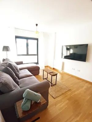 a living room with a couch and a tv at Casa do Xuli in Viveiro