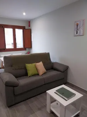 a living room with a couch and a table at El Rato Apartamentos Rurales in Navia