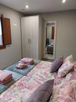 a bedroom with a large bed with pillows on it at El Rato Apartamentos Rurales in Navia