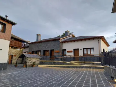 a building with a fence in front of it at El Rato Apartamentos Rurales in Navia