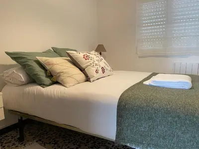 a bed with many pillows on it in a room at Oktheway Perbes Beach Vintage in Boebre