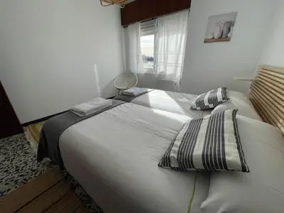 a white bedroom with two beds with pillows and a window at Oktheway Perbes Beach Vintage in Boebre