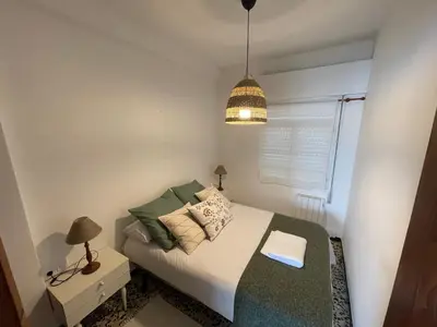 a small bedroom with a bed and a pendant light at Oktheway Perbes Beach Vintage in Boebre