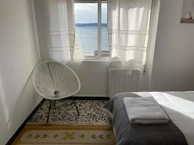 a white bedroom with a fan and a window at Oktheway Perbes Beach Vintage in Boebre