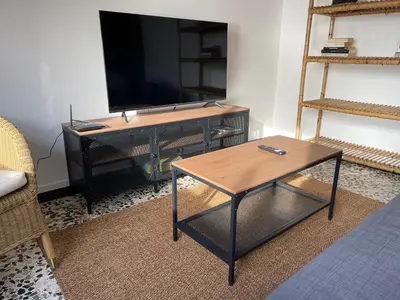 a living room with a tv and a coffee table at Oktheway Perbes Beach Vintage in Boebre