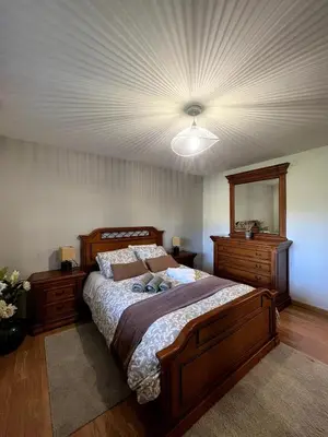 a bedroom with a large bed and a ceiling at O Balcon Do Oitaven, vuestra finca privada en Galicia in Pontevedra