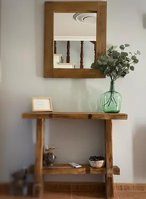 a mirror on top of a wooden shelf with a vase at O Balcon Do Oitaven, vuestra finca privada en Galicia in Pontevedra