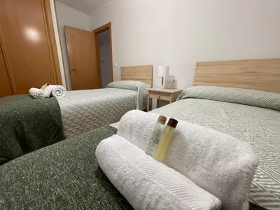 a room with two twin beds with white sheets at OKTHEWAY Castelao Street in Sarria