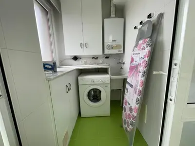 a kitchen with a table and chairs in a room at OKTHEWAY Castelao Street in Sarria