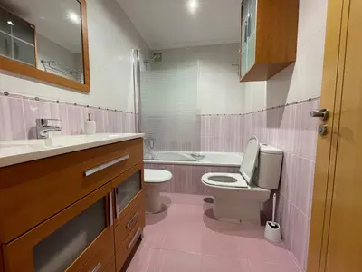a kitchen with a table and a stainless steel refrigerator at OKTHEWAY Castelao Street in Sarria