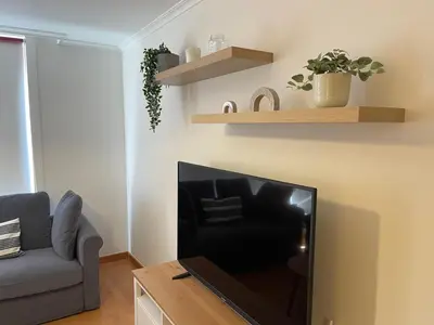 a living room with a couch and a table at OKTHEWAY Castelao Street in Sarria