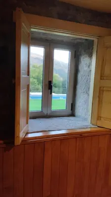 an open window in a room with a view at Rectoral de Prado in Piñeiro