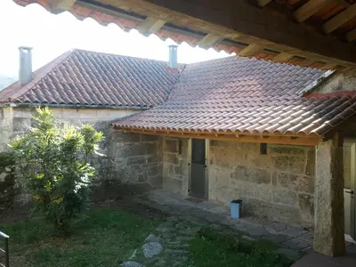 an outside view of a house with a tile roof at Rectoral de Prado in Piñeiro
