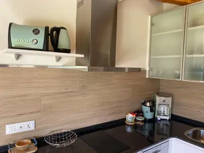 a kitchen with a counter top with a microwave at Apartamentos Turísticos VillaCordido Villaframil Ribadeo in Ribadeo