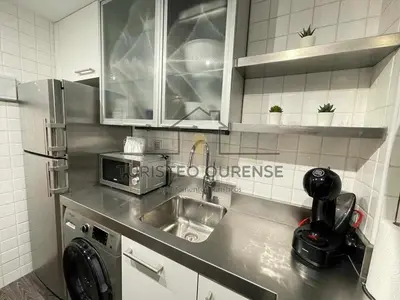 a kitchen with a sink and a microwave at A morada das perseidas in Ourense