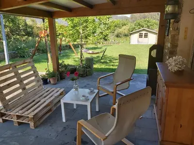 two chairs and a table on a patio at Casetón do Forno. in Lourenzá