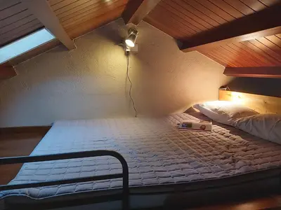 a large bed in a room with a ceiling at Casetón do Forno. in Lourenzá