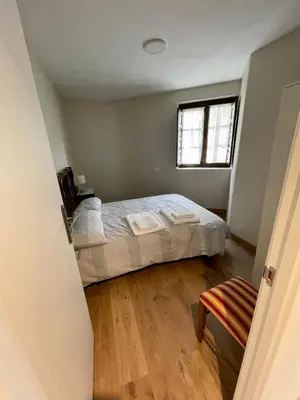 a bedroom with a bed and a window at CASA NARCISA - Perfecta para familias y grupos - Valle del Silencio in San Clemente de Valdueza