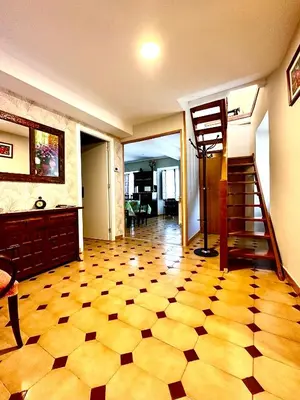 a room with a checkered floor and a stair case at CASA NARCISA - Perfecta para familias y grupos - Valle del Silencio in San Clemente de Valdueza