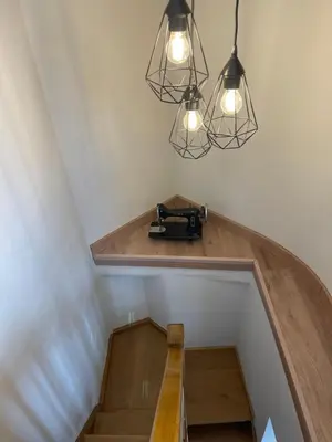 a set of stairs with two lights and a table at CASA NARCISA - Perfecta para familias y grupos - Valle del Silencio in San Clemente de Valdueza
