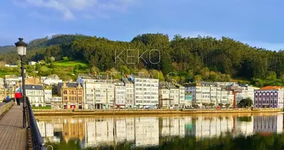 a group of buildings next to a body of water at Camiño Vello in Viveiro