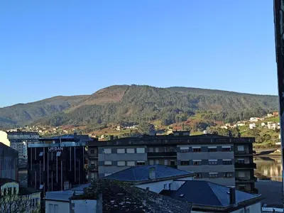 a view of a city with a mountain in the background at Camiño Vello in Viveiro