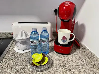 a counter with two bottles of water and a coffee maker at Afiador in Ourense
