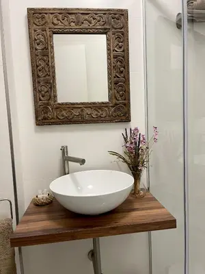 a bathroom with a bowl sink and a mirror at Afiador in Ourense