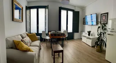 a living room with a couch and a table at Afiador in Ourense