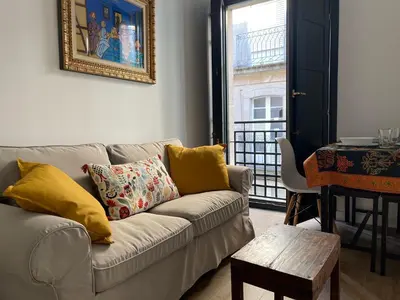 a living room with a couch and a table at Afiador in Ourense