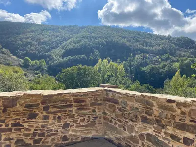 a stone wall with a mountain in the background at La Casita de Chocolate - Encanto Rural en Espinoso de Compludo - El Bierzo in Ponferrada