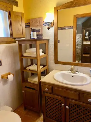 a bathroom with a sink and a mirror at La Casita de Chocolate - Encanto Rural en Espinoso de Compludo - El Bierzo in Ponferrada